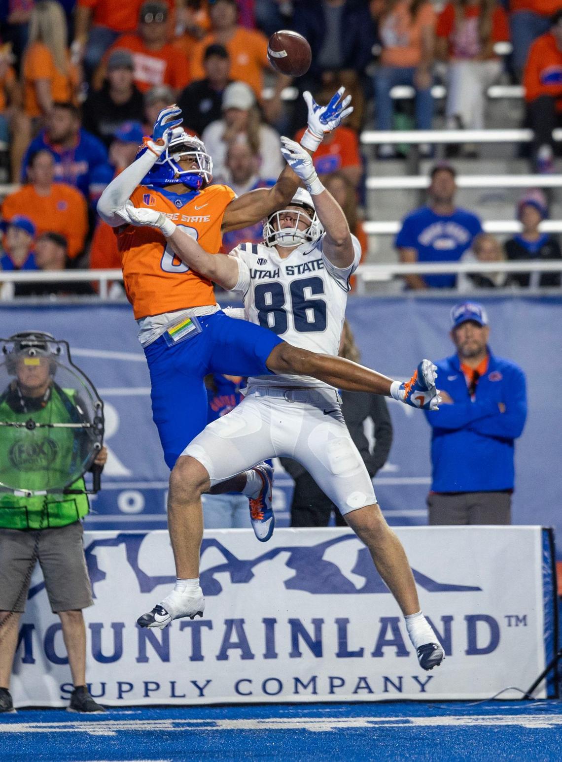 Boise State safety Ty Benefield breaks up a pass intended for Utah State tight end Will Monney.