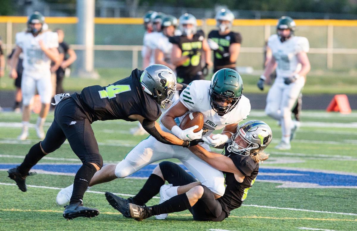 Mountain View’s Mason Chiles, left, helps bring down Eagle tight end Donovan Jones last fall.