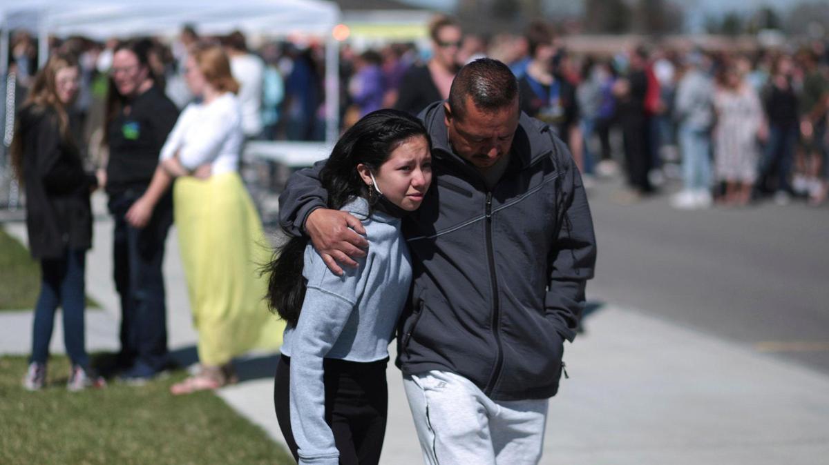 People embrace after a school shooting at Rigby Middle School in Rigby, Idaho in this 2021. file photo (John Roark /The Idaho Post-Register via AP)
