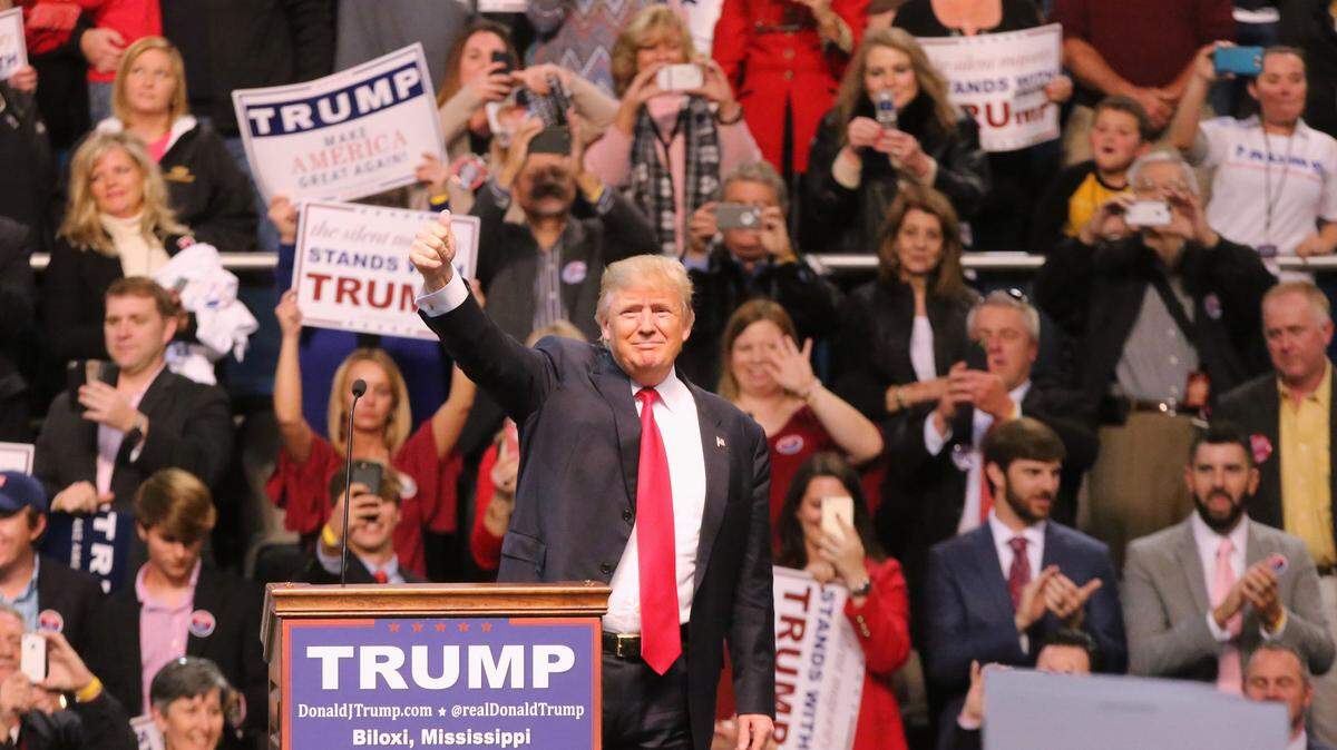 Then-presidential candidate Donald Trump greets the crowd during a January 2016 rally in Biloxi, Miss. Idaho candidates for several offices who didn't support Trump in 2016 are now invoking his name on the campaign trail.