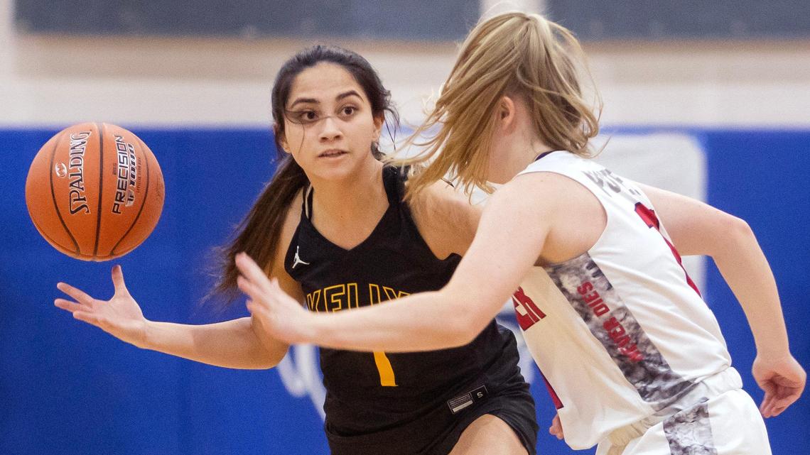 Bishop Kelly junior Keira Lizama dribbles the ball as Pocatello sophomore Taylee Rogers covers during the 4A state girls basketball tournament quarterfinals on Thursday at Timberline High School. Bishop Kelly won 51-33 over Pocatello.