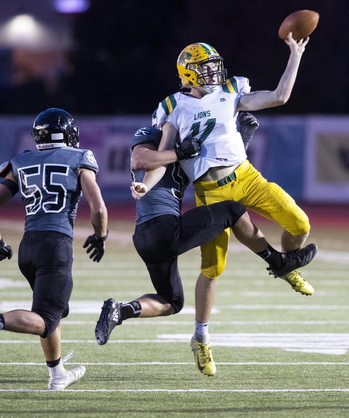 Borah’s right-handed quarterback, Austin Bolt, escapes a sack from Capital’s Charley Hastriter and Jayce French by getting off a pass with his left hand Thursday at Dona Larsen Park.