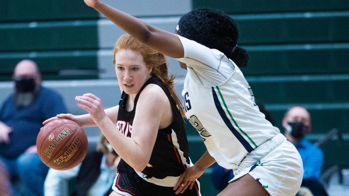 Boise guard Elle Dingel drives on Mountain View’s D’Nia Williams in the 5A District Three girls basketball championship at Eagle High School in Eagle. Both teams qualified for state.