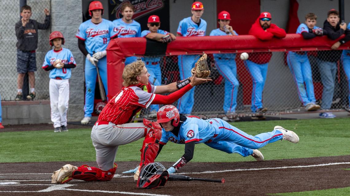 Homedale’s Payton Fine slides safely into home before Weiser catcher Brenett Marshall can apply the tag Monday.