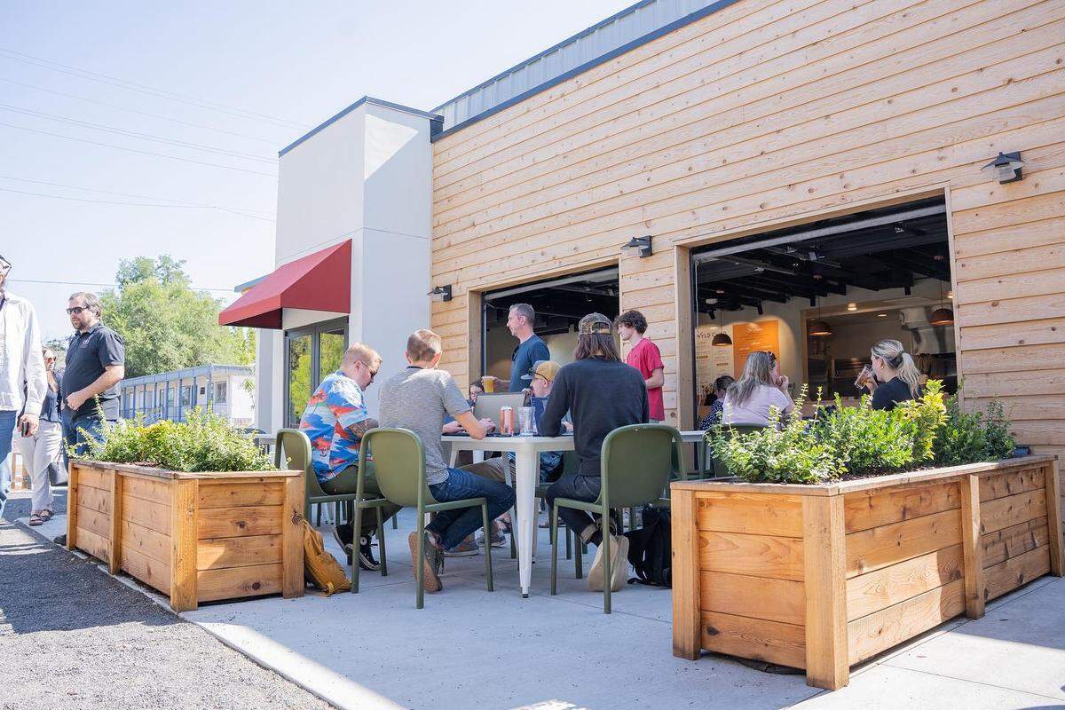 Customers dine at the Wyld Child restaurant on the Boise Bench. The new apartments would be across the street, at left.
