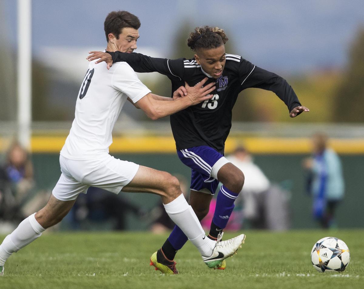 Rocky Mountain senior Brandon Poole, right, and Timberline’s Nathan Ashworth fight for control of the ball during the 5A District Three championship game Oct. 10 at Mountain View High.