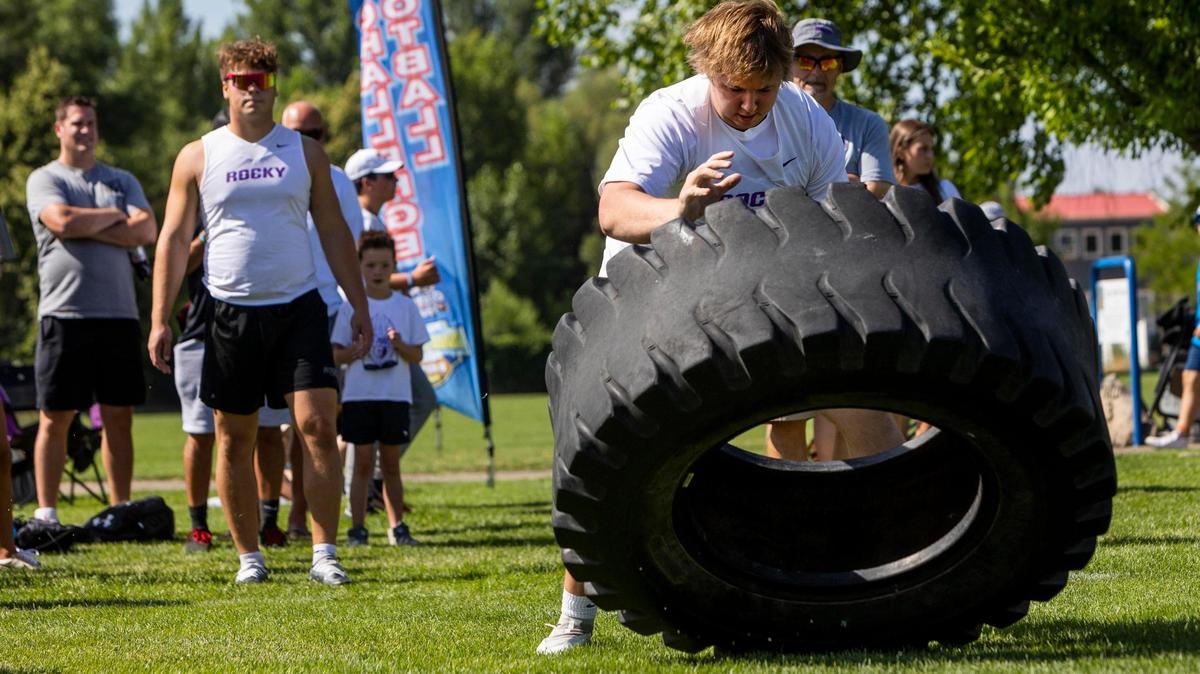 Rocky Mountain offensive lineman Jackson Fullmer, a Kansas State commit, flips a tractor tire during a relay with teammates at the Potato Bowl 7-on-7 Tournament’s lineman challenge Saturday at the Optimist Youth Sports Complex in Boise.