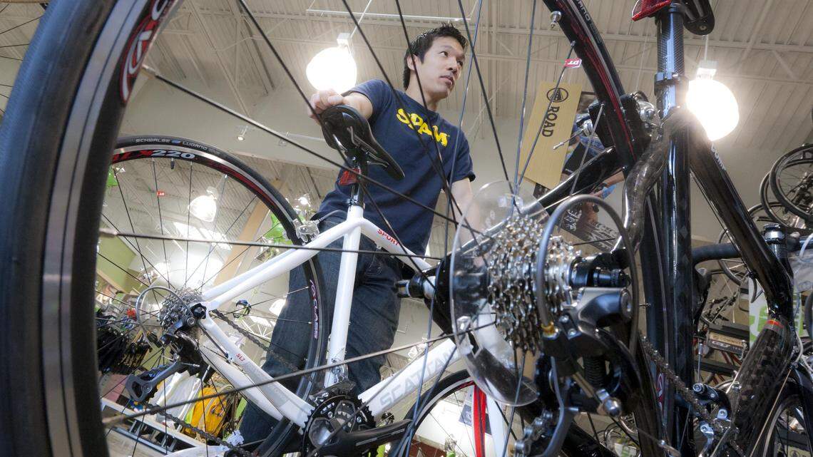 Customer Solomon Lee, Boise, who was looking for a good road bike, gets assistance at Performance Bicycle during the grand opening of the store in 2011. The store will close soon.