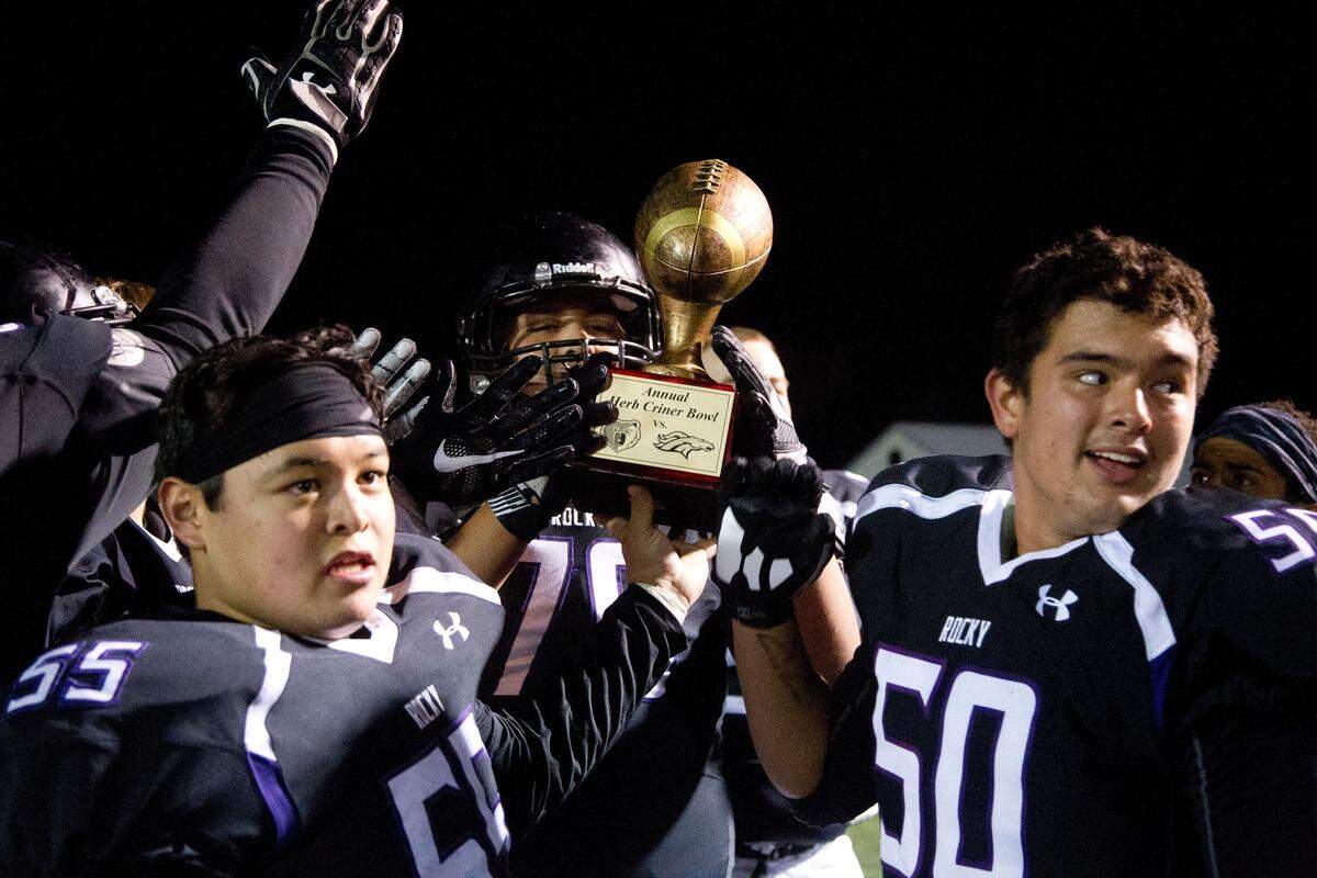 Rocky Mountain hoists the Herb Criner Bowl trophy after beating rival Eagle 34-9 last season.