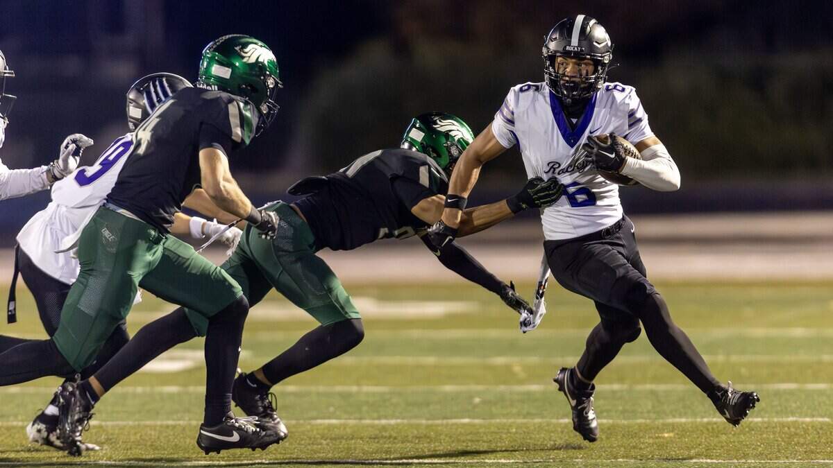 Rocky Mountain wide receiver Rasean Jones finds yards after the catch defended by Eagle's Trey Ellis and Dallin Snooks in the quarterfinals of the 6A football playoffs at Eagle, Friday, Nov. 7, 2025.