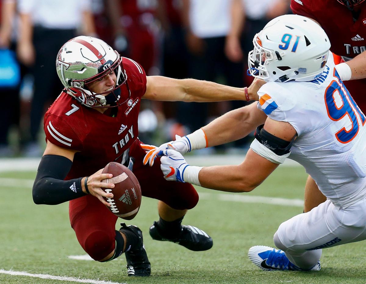Troy quarterback Kaleb Barker (7) is sacked by Boise State defensive end Durrant Miles on Saturday at Troy.