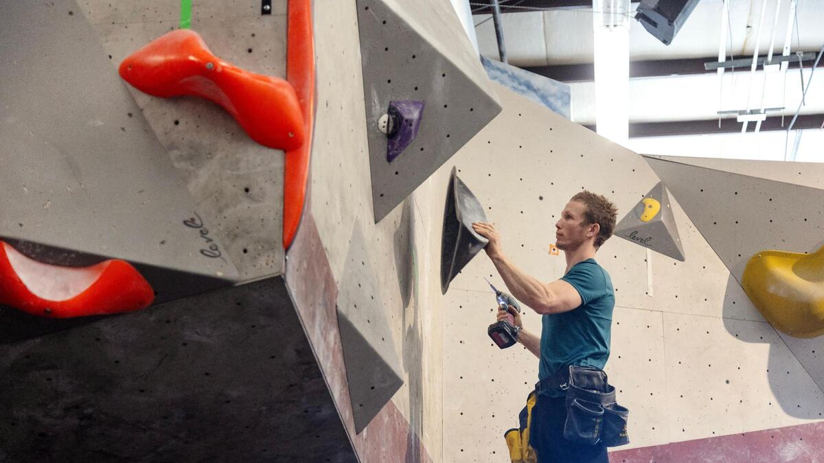 Brannon Frank, head route setter at Asana Climbing Gym, works on a wall ahead of the Idaho Bouldering Championship in December 2022. The gym announced Tuesday that it will close later this year.