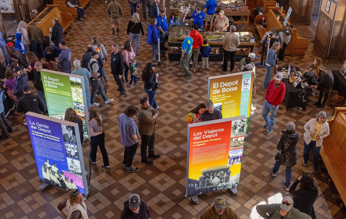 Signs give the history of the Boise Depot in both English and Spanish during its 100th anniversary celebration.