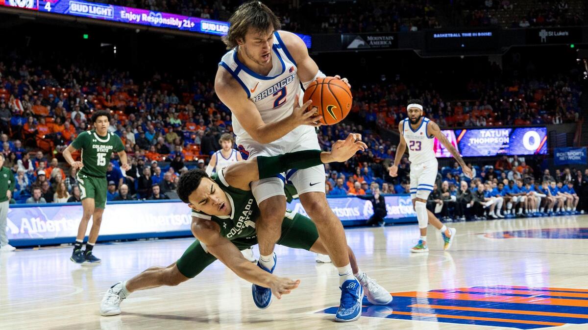 Boise State forward Tyson Degenhart grabs a loose ball before Colorado State guard John Tonje can take possession in the first half Saturday at ExtraMile Arena in Boise.