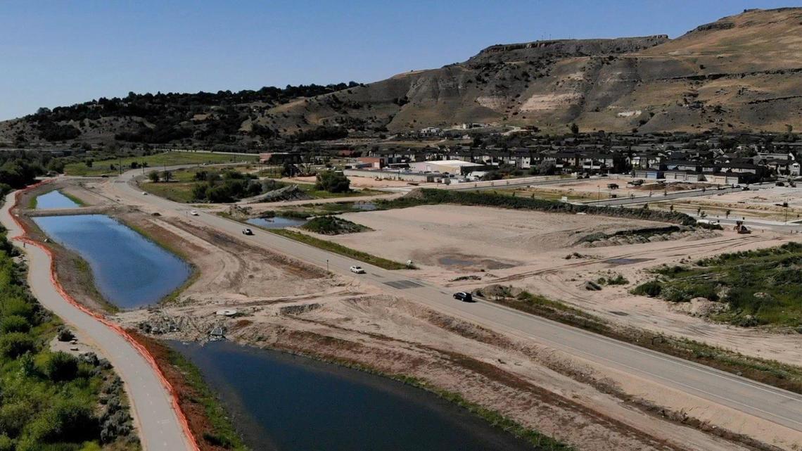 Warm Springs Avenue would be widened between Wise Way (roughly at the turn in the road) and Eckert Road (extending east out of the frame). The Boise City Council and the neighborhood association prefer two lanes with roundabouts. The Greenbelt is far left with orange fencing, and the retail/commercial/high density development will be in the center.