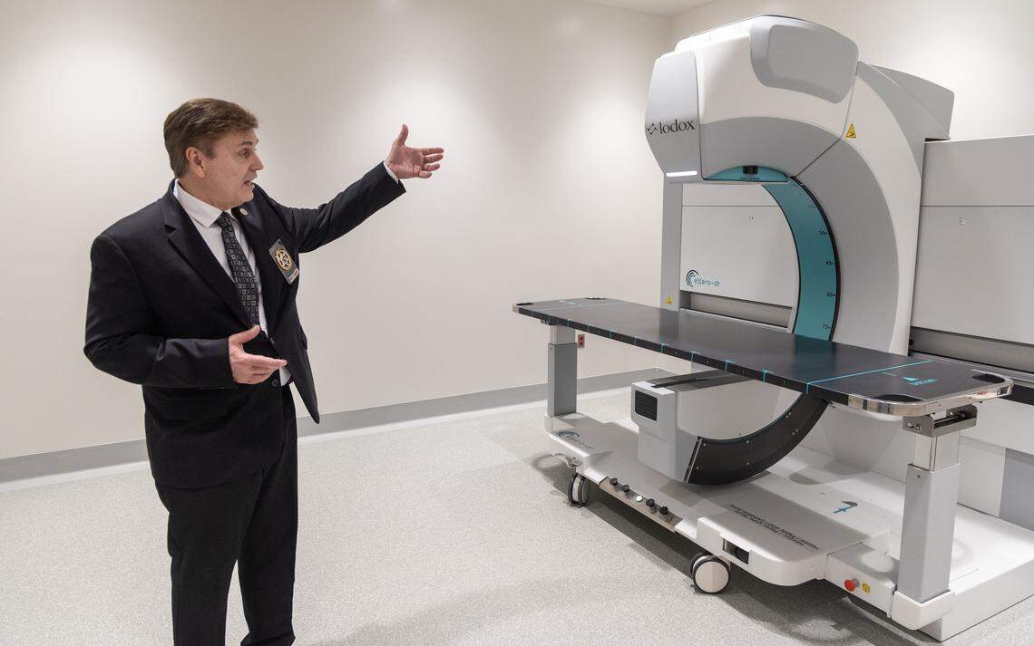 Chief Deputy Coroner Brett Harding points out the capabilities of a Lodox machine used for full body X-ray imaging at the Ada County Coroner's office.