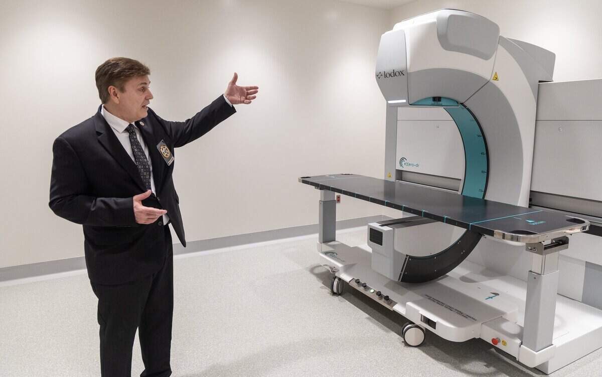 Chief Deputy Coroner Brett Harding points out the capabilities of a Lodox machine used for full body X-ray imaging at the Ada County Coroner's office.