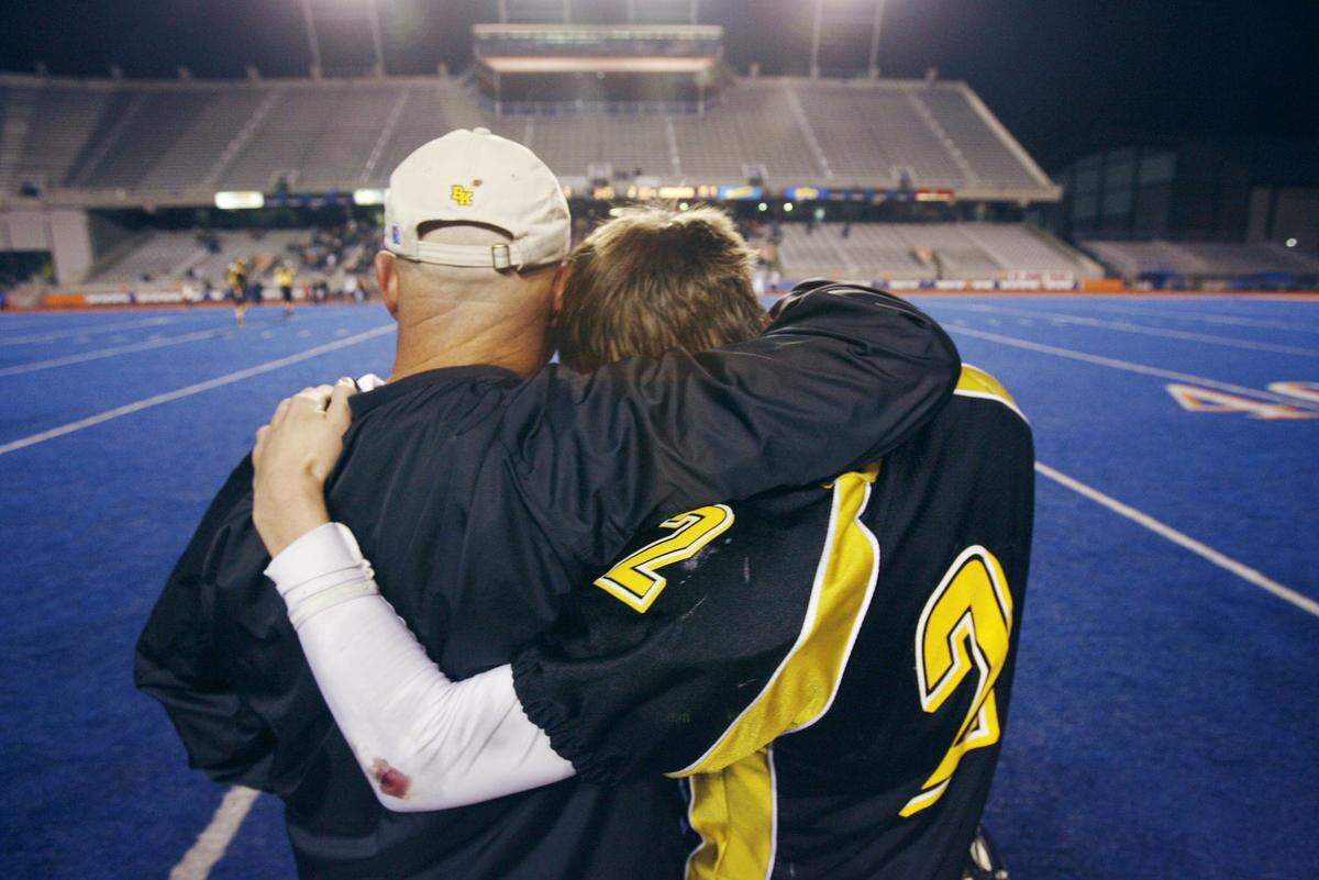 Tim Brennan embraces quarterback Kyle Cefalo after the Knights lost the 2006 state title game at Albertsons Stadium. “It was just a hug to show him how much he means to  me” Cefalo said.