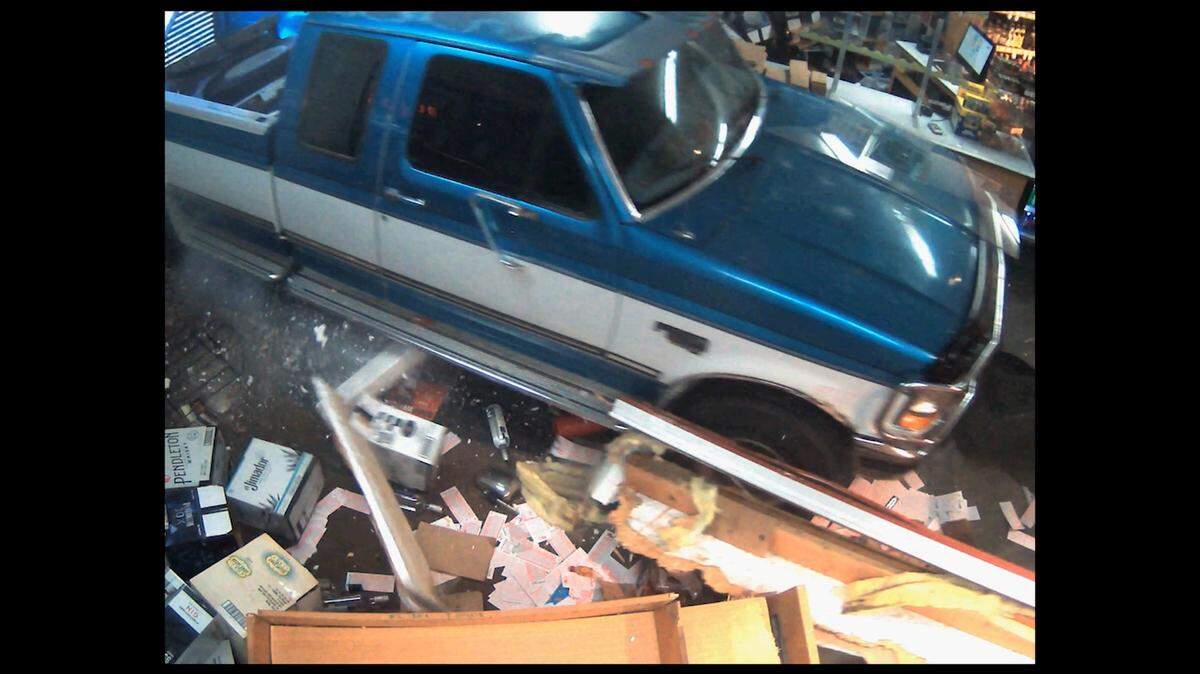 A security camera captures video of a man driving his pickup truck through the front of a Nampa liquor store on April 12.