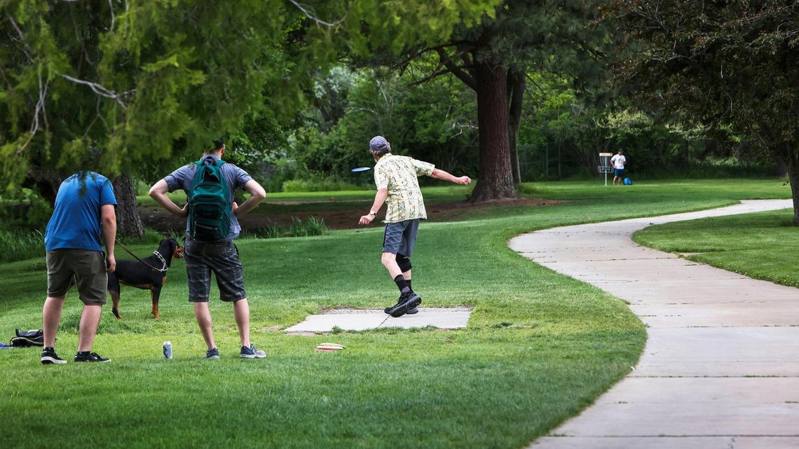 Rick Allison, throwing, Franklin Brien and Jason Walsh had never met before meeting in line to play a round of disc golf at Ann Morrison Park on Wednesday, May 25, 2022.