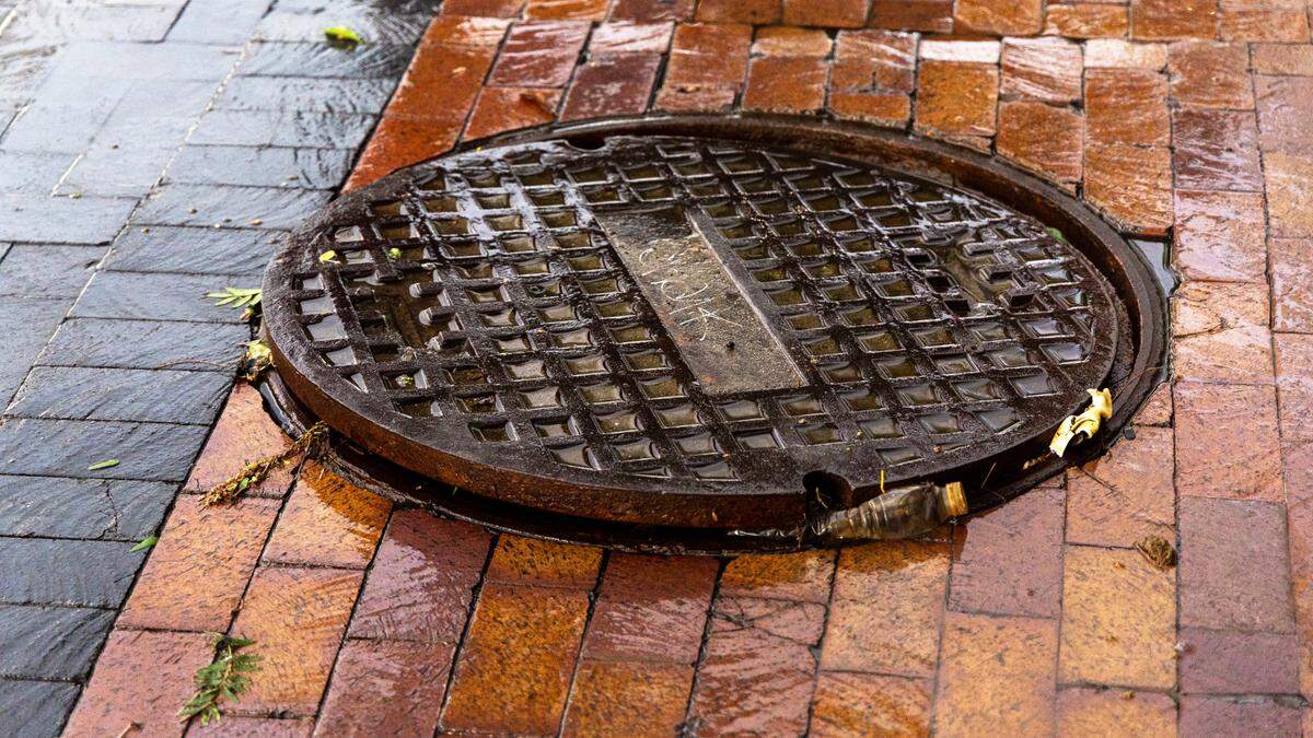 A sewer cover propped open in downtown Boise.
