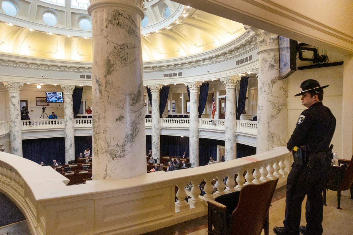 An Idaho State Police officer watches over the Senate chamber during session on Wednesday, March 16, 2022. Budget-setting lawmakers rejected a proposal from Gov. Brad Little to give law enforcement officers an additional 6% raise this year. But lawmakers gave ISP employees pay enhancements separately, one example of a budgeting strategy to target raises agency-by-agency.