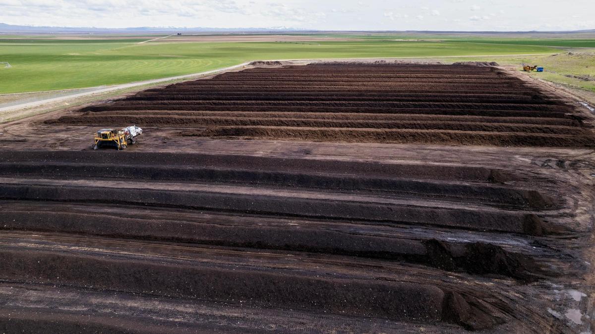The city of Boise’s Twenty Mile South Farm uses windrow composting — long rows of compost piles that are then turned by a large machine to mix in oxygen.