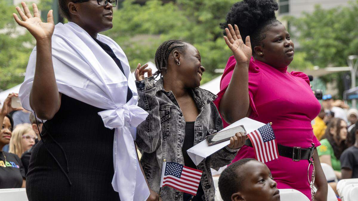 People take their oath of citizenship to become United States citizens during a celebration of World Refugee Day in Boise, Idaho on Saturday, June 17, 2023.