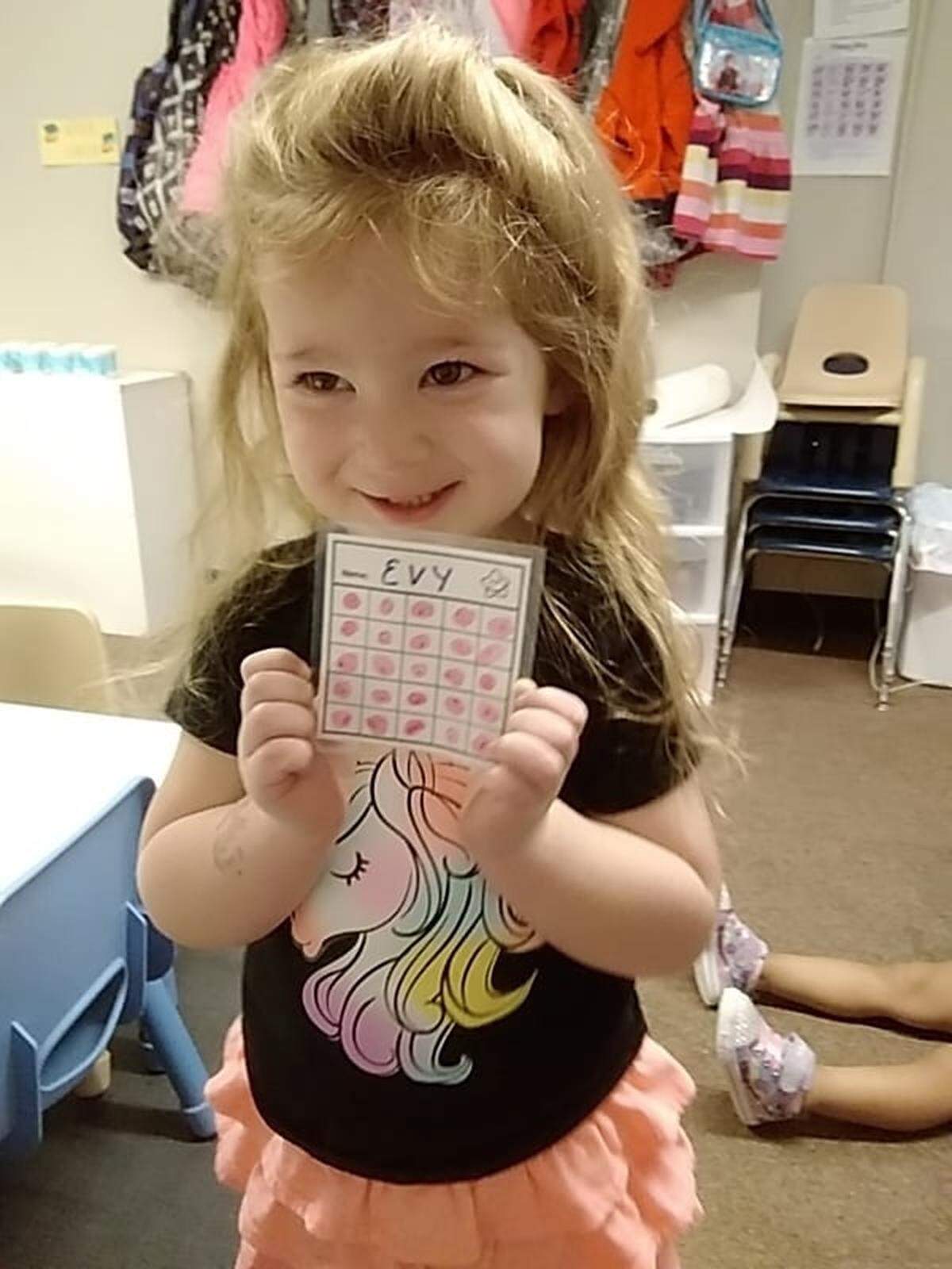 Everay Acker shows off her preschool project.