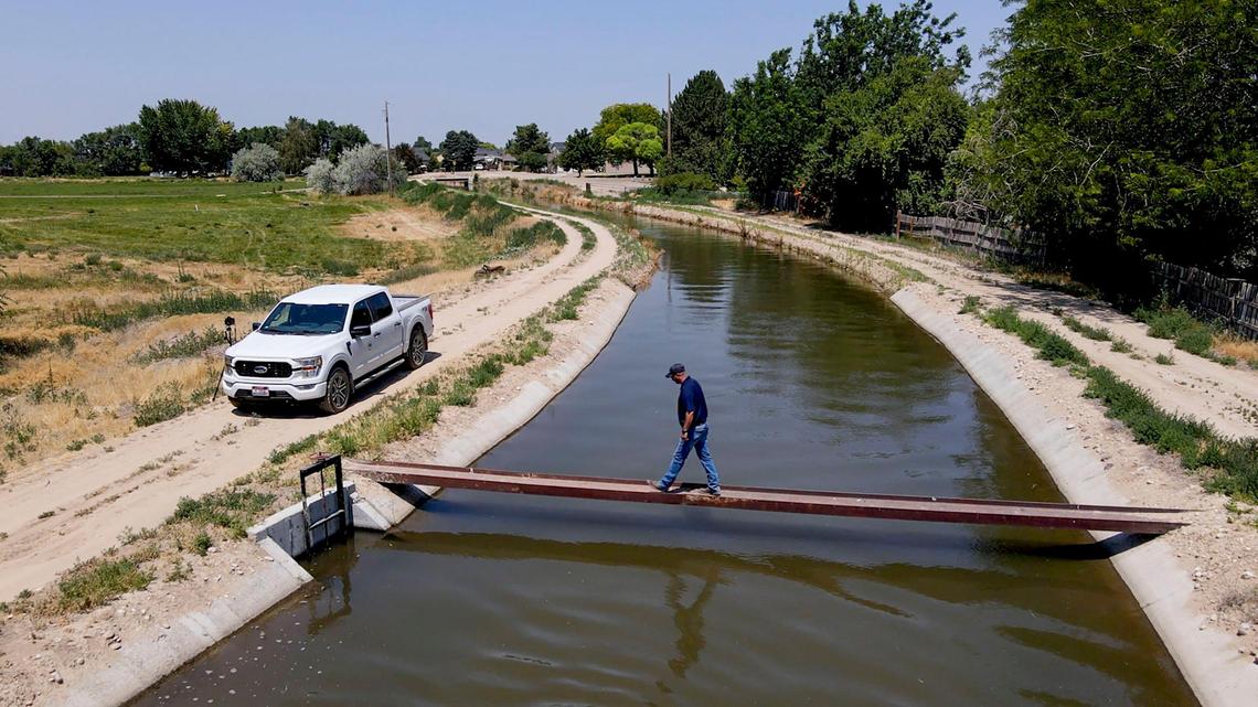 Pioneer Irrigation District Superintendent Mark Zirschky crosses the Phyllis Canal after checking a drainage refill pump in the Caldwell-Nampa area. Cities like Boise and Meridian currently have no ordinances restricting water use during the drought.