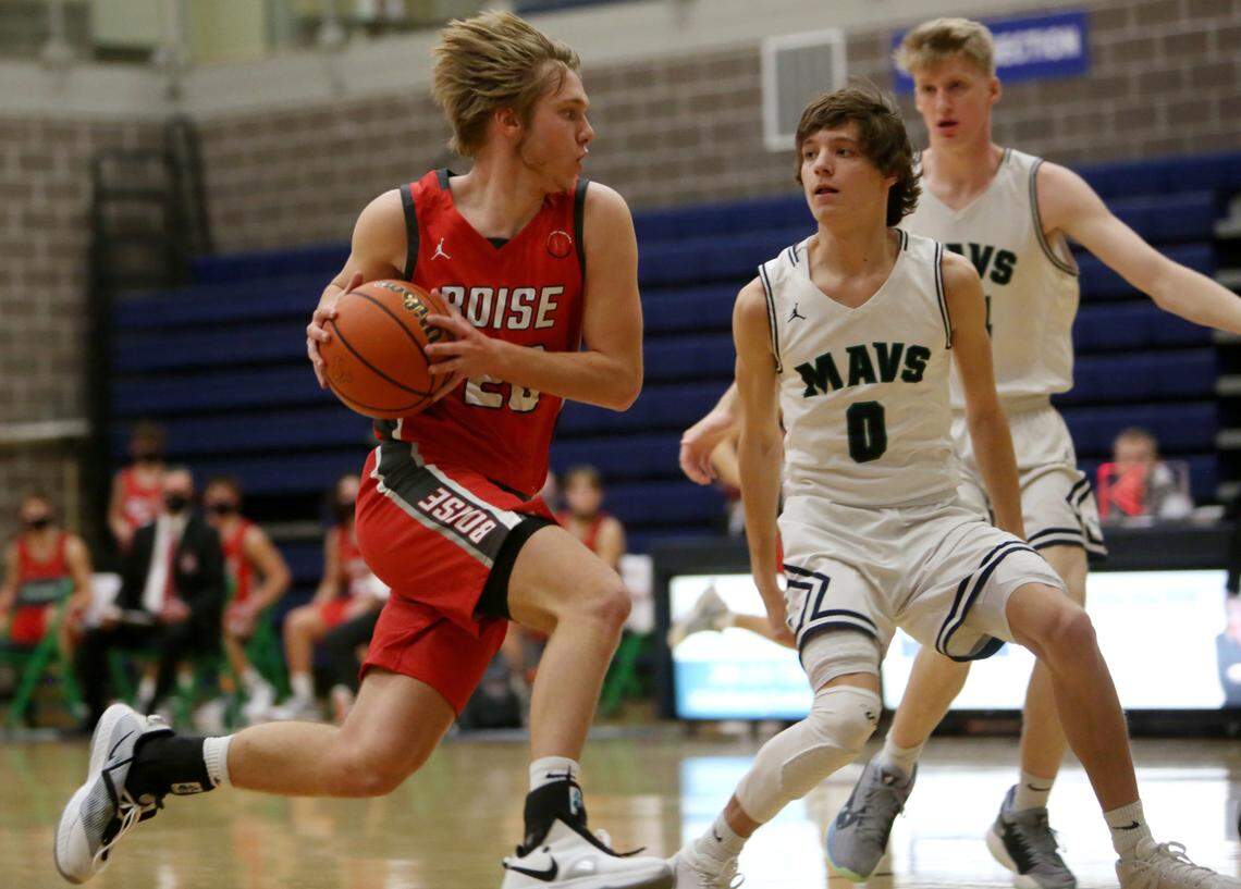 Boise’s Whitt Miller drives past Mountain View’s Dylan Logsdon on Tuesday at Mountain View High School in Meridian.
