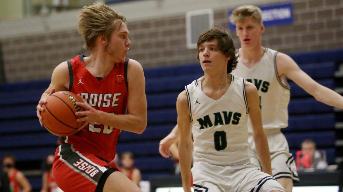 Boise’s Whitt Miller tries to drive past Mountain View’s Dylan Logsdon on Jan. 19 at Mountain View High School in Meridian. Both teams qualified for the 5A state tournament this week.