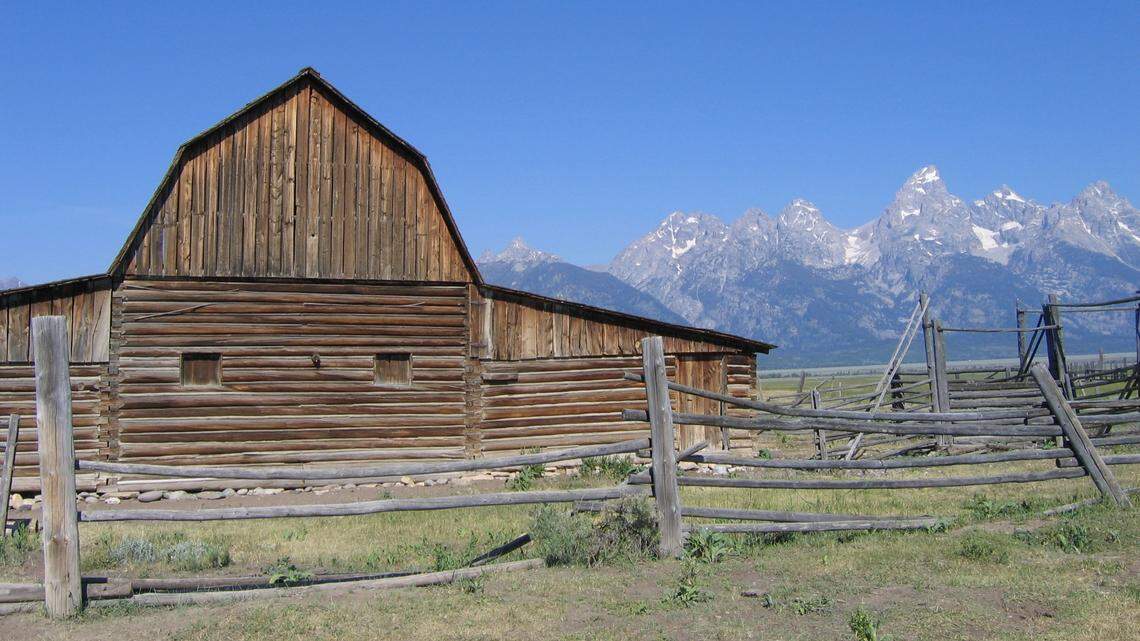 The John Moulton Barn is seen on Mormon Row. A man held illegal dirt bike races and damaged the historic hay field there, officials say.