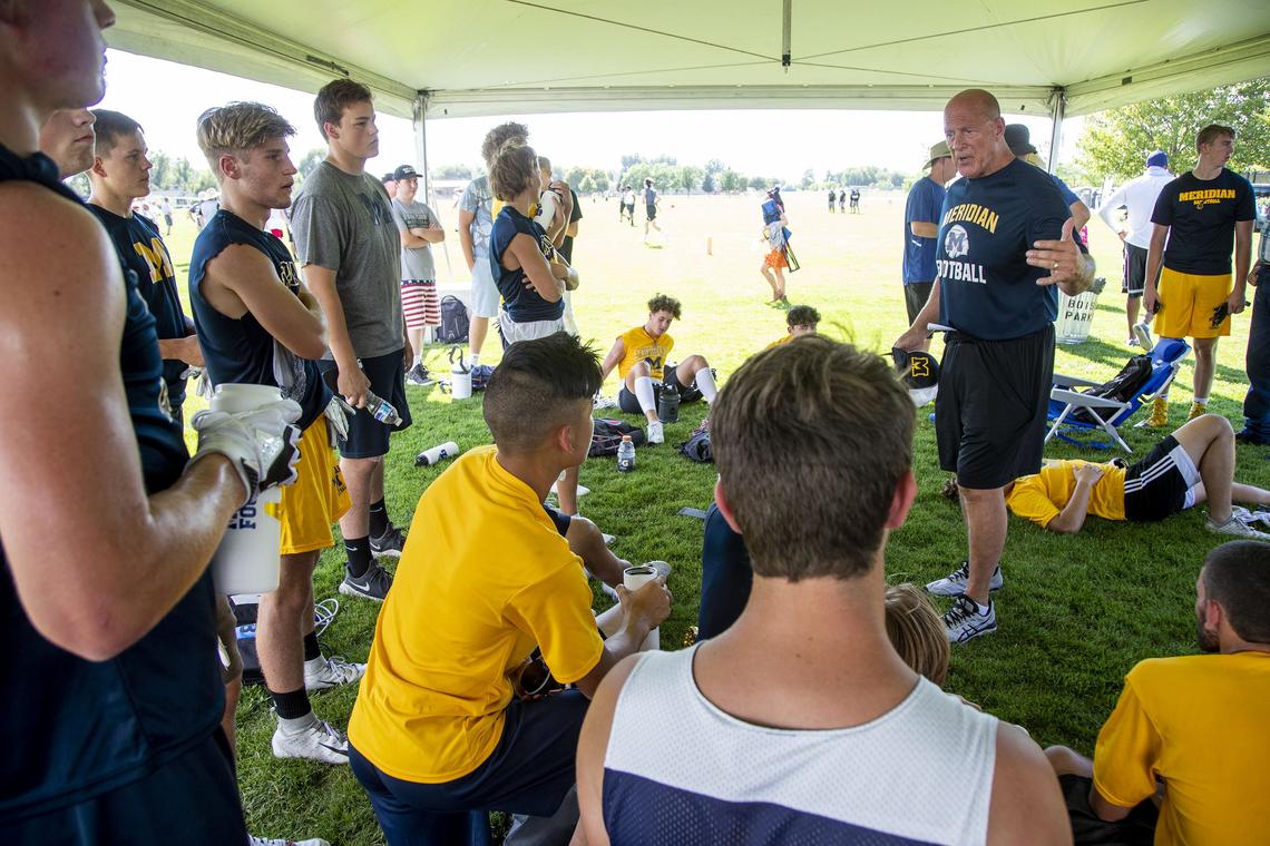 Meridian High football coach John Zamberlin addresses his players between games at the annual Famous Idaho Potato Bowl 7-on-7 tournament Friday at the Optimist Youth Sports Complex in Boise.