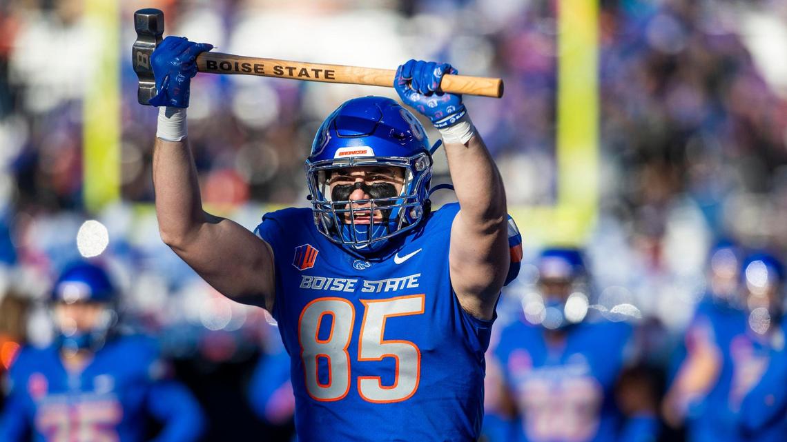Boise State tight end Matt Lauter holds up the Dan Paul Hammer as the Broncos take the field Saturday before their 28-16 loss to Fresno State in the Mountain West championship game.