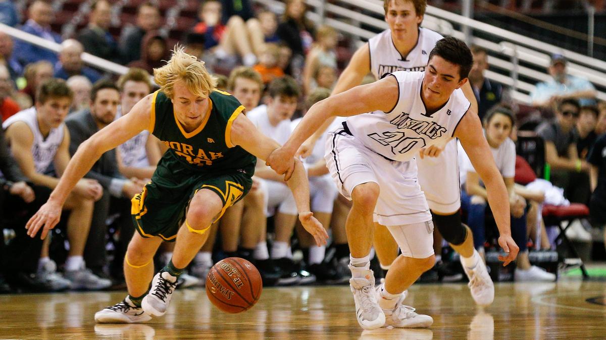 Borah’s Austin Bolt and Eagle’s Jordan Kemp scramble for a loss ball during the 5A state tournament semifinals Friday at the Ford Idaho Center.