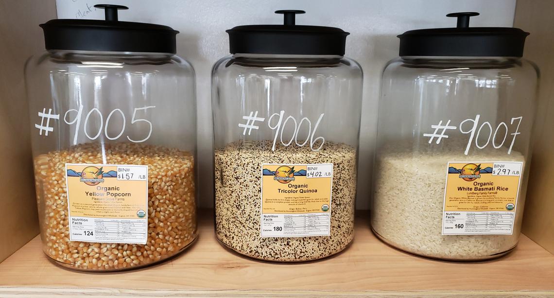 Dry beans, popcorn, quinoa, rice and other grains are packed in glass jars.