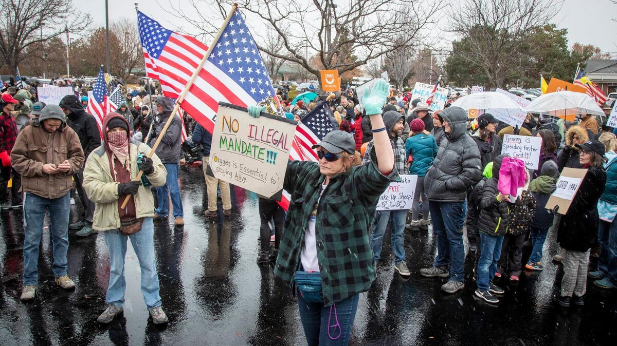 Protesters gather in front of Central District Health to protest mandated masks and other restrictions in four Idaho counties in January 2021. The city of Boise will hire security to enforce its own mandate in city buildings.