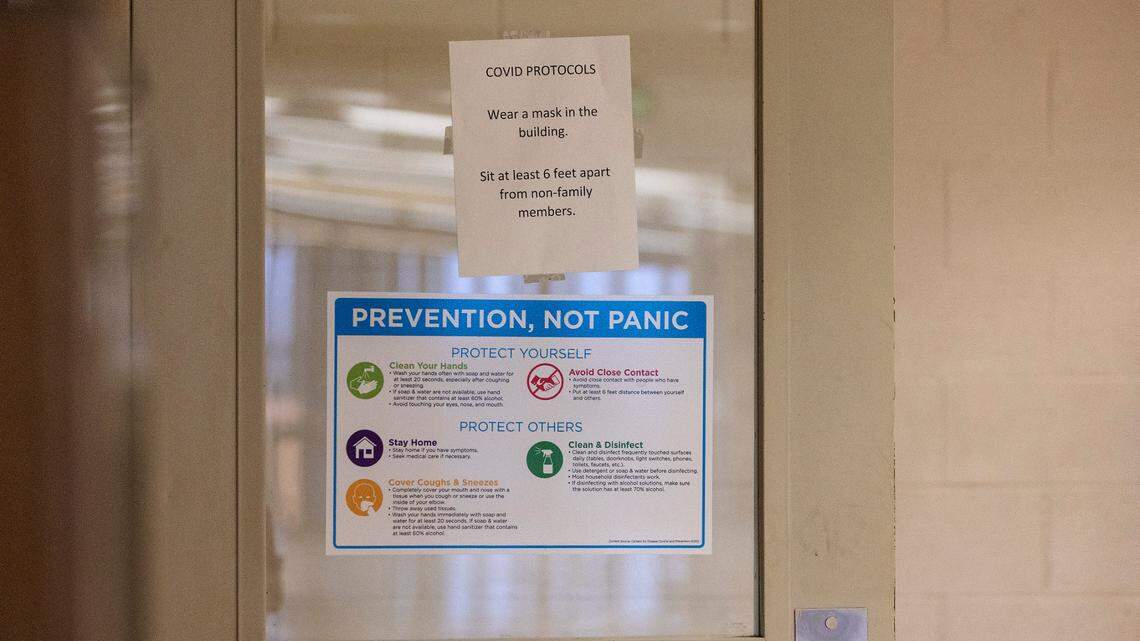 A sign posted on the gym door at Mountain View High School in Meridian reminds students to socially distance and wear face masks on Thursday, Sept. 9, 2021.