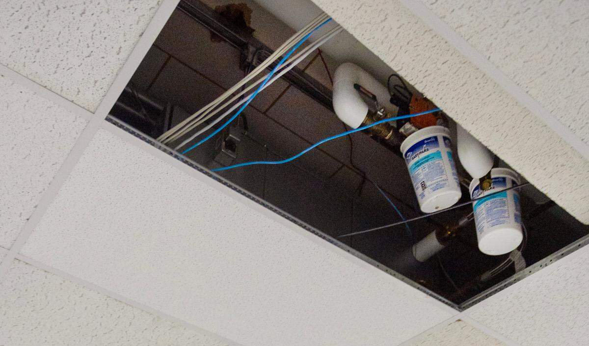 Buckets hang from the ceiling in the main hallway to collect leaking water at Valley View Elementary in Bonners Ferry, Idaho.