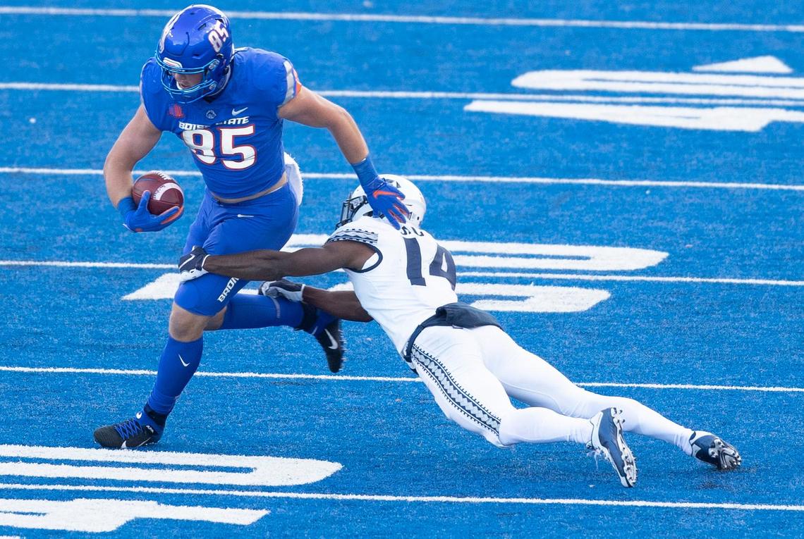 Boise State tight end John Bates (85) catches a pass against defense by Utah State cornerback Zahodri Jackson (14) during game at Albertsons Stadium. Boise State defeated Utah State 42-13. Saturday October, 24, 2020.