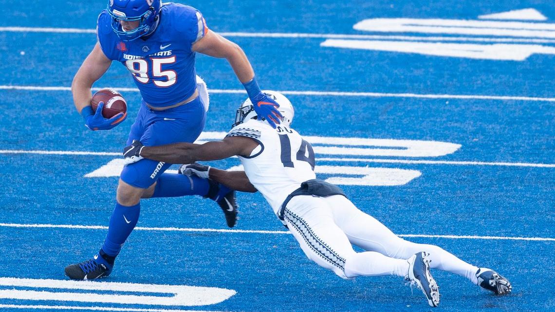 Boise State tight end John Bates catches a pass against defense by Utah State cornerback Zahodri Jackson on Saturday at Albertsons Stadium.