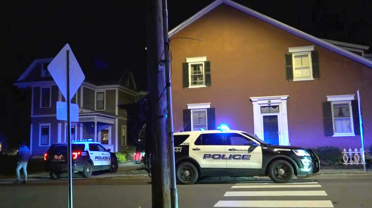 In this still frame from video provided by WCAX-TV in Burlington, Vermont, police vehicles stand on a street and in a driveway near a scene Saturday where three men of Palestinian descent were shot and injured.