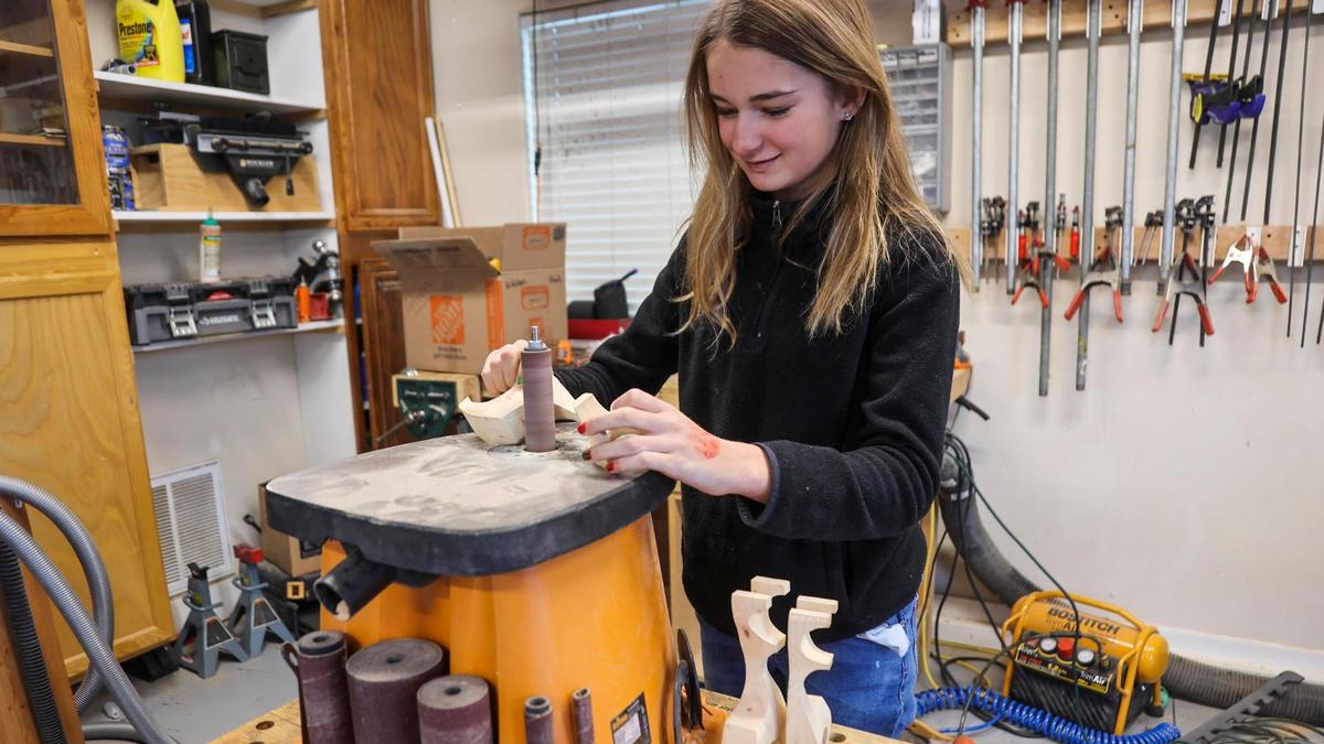 Quinn Nordick, 12, sands down a wooden reindeer in the garage of her Meridian home on Friday, Dec. 17, 2021. Quinn’s mother, Marji Nordick, calls Quinn her “tinker fairy” because she loves to work with her hands and build things. “Her brain never stops,” Nordick said.