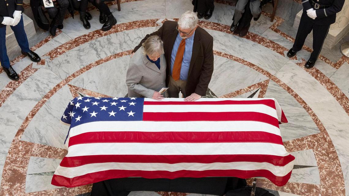 Francee Batt, with her son Dan Averill, approaches the casket of her husband, former Gov. Phil Batt, after a memorial in his honor, Thursday, March 9, 2023, at the Capitol in Boise. Gov. Batt served as Idaho’s governor from 1995 to 1999. He died Saturday on his 96th birthday.
