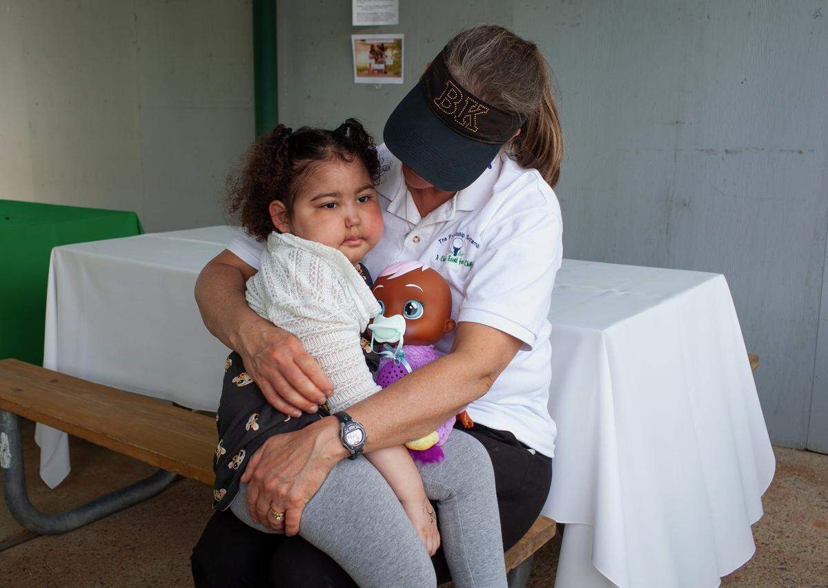 Julianne Russell holds the Friendship Scramble’s 2022 recipient, Ziyah Lucius, who was 5 years old at the time. Ziyah died just seven months after this picture was taken.