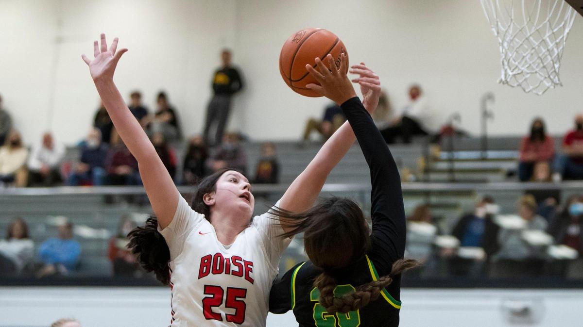 Boise senior Ashley Banks blocks a shot by Borah’s Jayden McNeal but is called for a foul in the 5A District Three semifinals Saturday at Capital High.