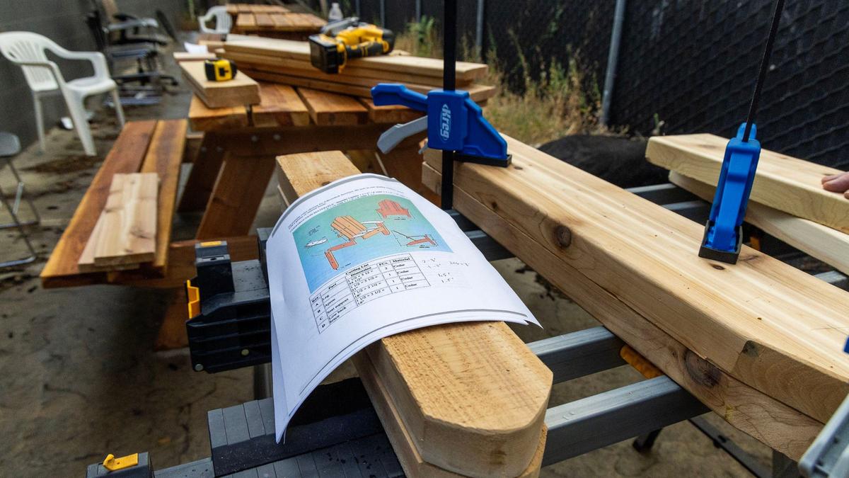 Instructor Ronald Alexander gives students booklets with instructions to build Adirondack chairs. He wants them to develop the independence to read and figure out the next steps on their own, he said.
