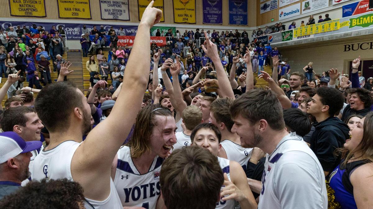 The College of Idaho men’s basketball team celebrates a 76-61 victory over Xavier University of Louisiana in the second round of the NAIA tournament on Wednesday.