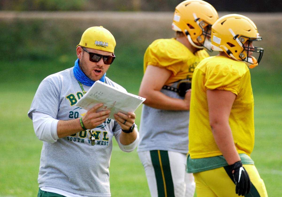 Former Borah football coach Jason Burton, left, resigned after five seasons leading the Lions.